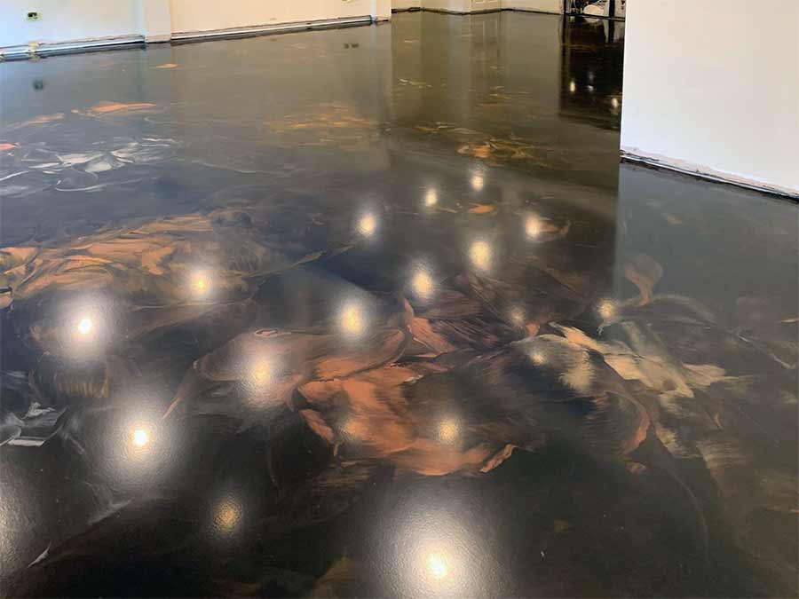 Dark metallic epoxy floor with warm copper movement